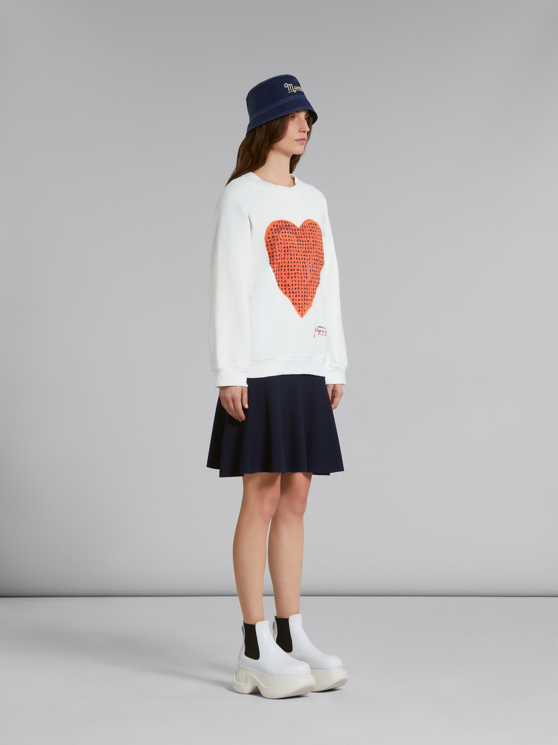 White sweatshirt with wordsearch heart print